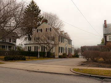 Amityville Horror house in Amityville, New York after attic windows were changed from quarter-circles to standard rectangular windows