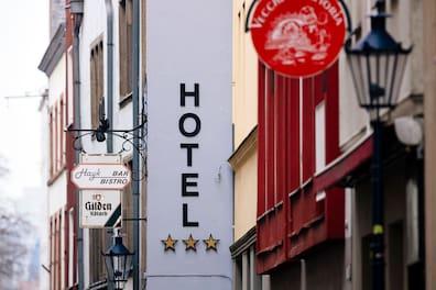 A hotel in Cologne's Old Town with a sign indicating three hotel stars.