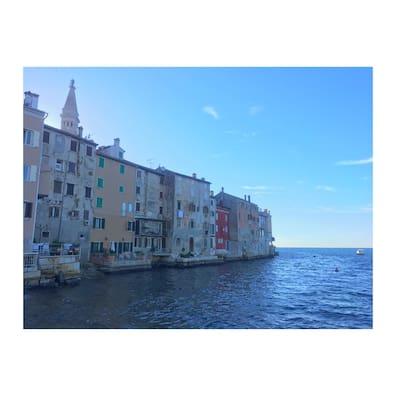 The old town of Rovinj is located on a peninsula. Its houses are packed tightly against the water.