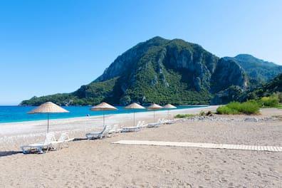 Morning on the beach in the village of Cirali. Blue bay in the Mediterranean at sunrise. Landscapes of the Lycian Way.