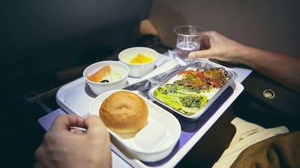 A warm meal is now only offered for free by very few airlines. (Stock photo)