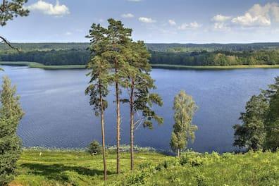 View over a lake in Aukštaitija National Park, Lithuania, with forests in the background
