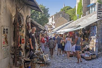 Tourists explore the old town of Mostar
