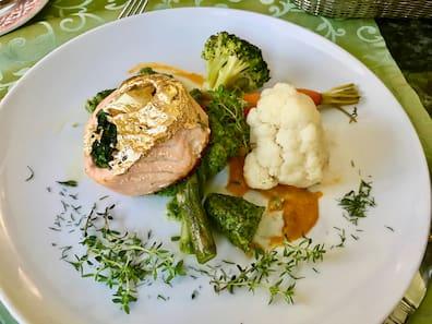 Salmon with gold leaf in lobster sauce with spinach noodles at Pod Łososiem Restaurant.