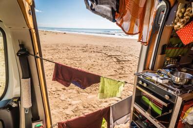 View from a campervan out onto the beach.