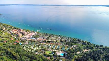 Wide view of the 'La Rocca Camping' facility in the bay of San Pietro on Lake Garda.