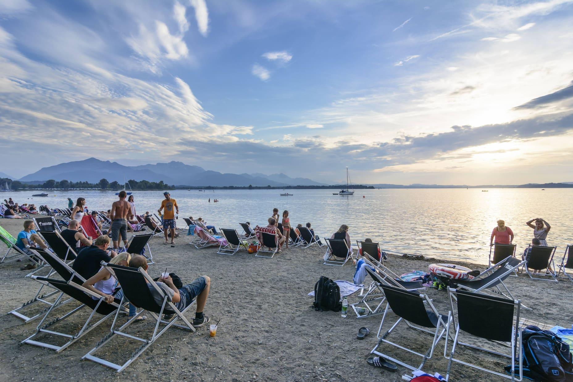 Beach vibes at Lake Chiemsee in Übersee-a place with beach chairs among other amenities.
