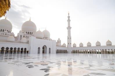 The huge mosque features 82 domes, four minarets, and the world's largest hand-knotted carpet.