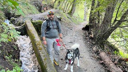 A fresh, cool morning in the light-filled deciduous forests along the Great Suone of Vex: Hiking guide Guillaume Savriacouty always travels with his Alaskan Malamute dog Runa.
