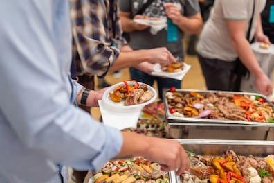 People serving themselves at a buffet.
