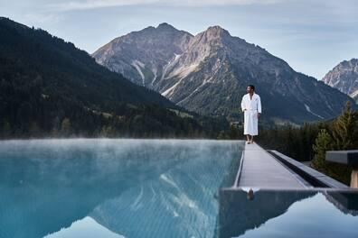 A walk by the outdoor pool with a wonderful view of the surrounding mountain landscape.
