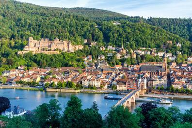 View over Heidelberg with Neckar river, the old bridge, red rooftops of the old town, and castle above