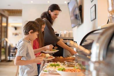 Woman with two kids at the hotel buffet.