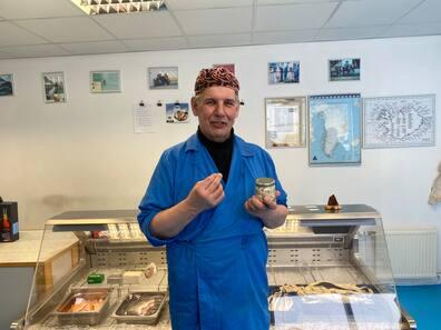 Fishmonger Kári Thór Jóhannsson with a jar of the acquired taste delicacy, fermented shark.