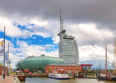 The elliptical building is the Climate House. It is located in Bremerhaven's Havenwelten. The German Maritime Museum and the Zoo by the Sea are right next door.