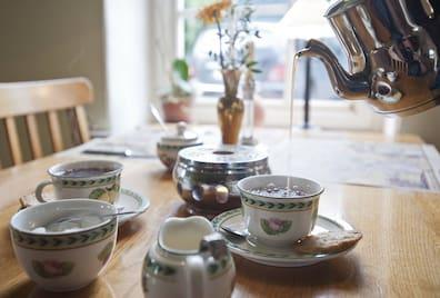 Pouring tea into a cup: An East Frisian tea ceremony is a perfect activity for a gray, cool rainy day at the North Sea.