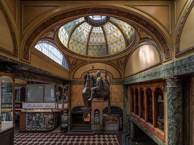 A historical passage with a statue hanging as a horse from the ceiling and the rider sits on the belly.